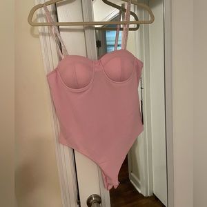 Pink bodysuit with rhinestone straps. Never worn